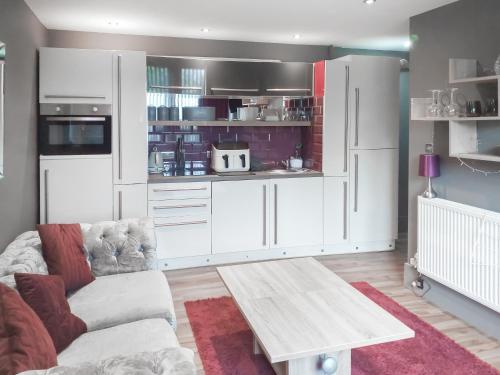 a living room with a couch and a kitchen at The Inn And Around in Kenton