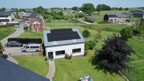 a house with solar panels on top of it at Bastogne Maison de vacances avec sauna in Bertogne