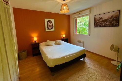 - une chambre avec un lit, une fenêtre et 2 lampes dans l'établissement Joli T2 niché dans les arbres au cœur du bassin, à Audenge