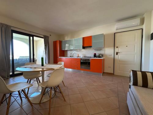 a kitchen with a table and chairs in a room at NG Collection I Graniti in Olbia