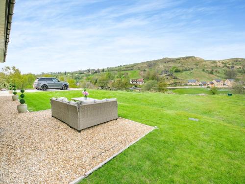 a car parked in a yard with a couch in the grass at The Stables in Littleborough