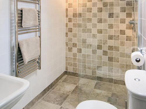 a bathroom with a toilet and a sink at The Stable - Hw7461 in Henrys Moat