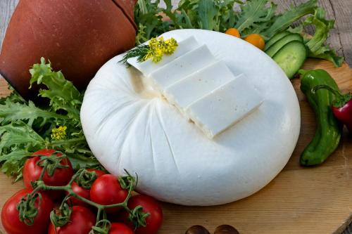 a white pumpkin with a block of cheese on it next to vegetables at Örsmaris Boutique Hotel in Marmaris
