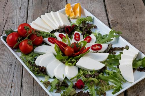 a plate of food with vegetables on a wooden table at Örsmaris Boutique Hotel in Marmaris