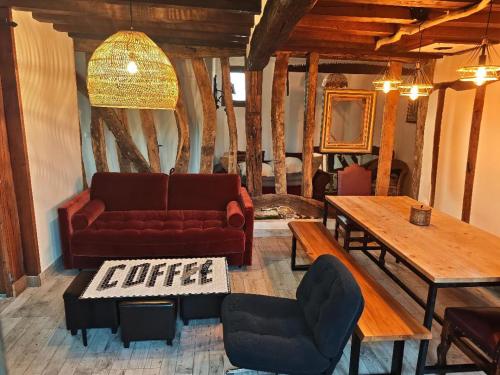 a living room with a couch and a table at Golf&Love in Normandy in Sainte-Opportune-du-Bosc