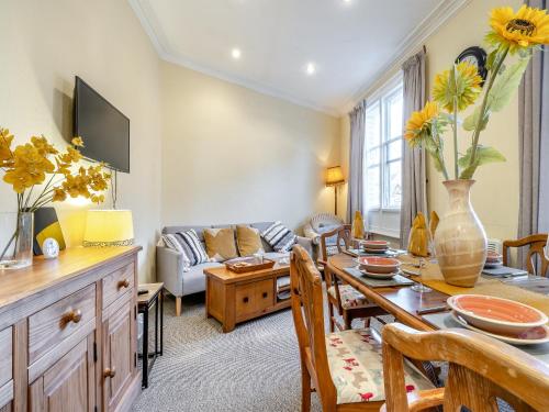 a living room with a table and a couch at The Flat in Whitchurch