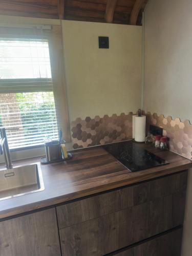 a kitchen with a wooden counter top and a sink at PipoParel in Ravels
