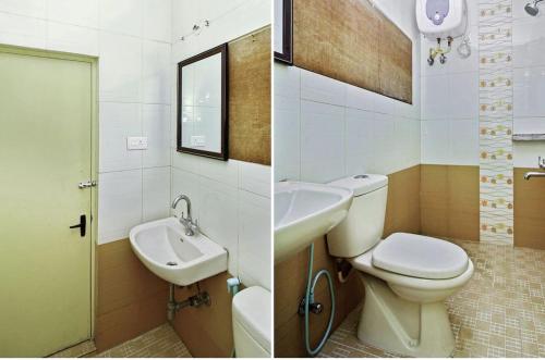 a bathroom with a toilet and a sink and a mirror at Happy Valley in Kodaikānāl