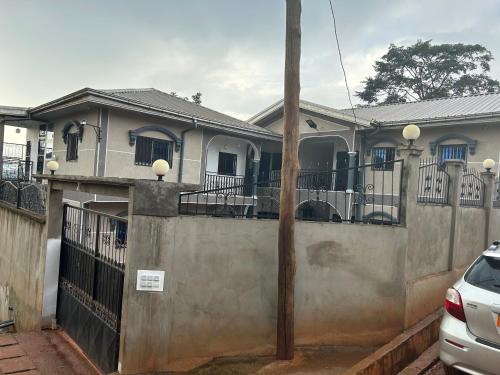 a house with a fence and a pole at KSHP NKOZOA ydé in Yaoundé