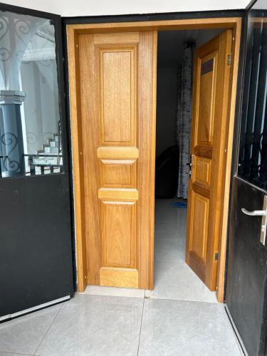 an open wooden door in a room with at KSHP NKOZOA ydé in Yaoundé