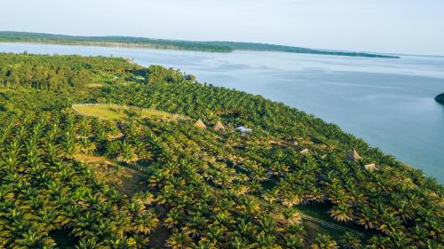 an island in the middle of a body of water at Bugoma Palms Resort Sand Beach 