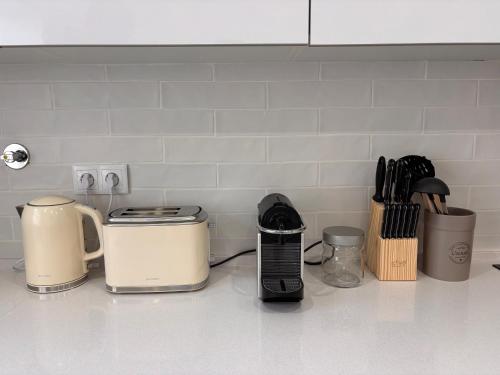 a kitchen counter with appliances on a white counter top at Charming Baixa IV - 3 Room APT in Lavradio