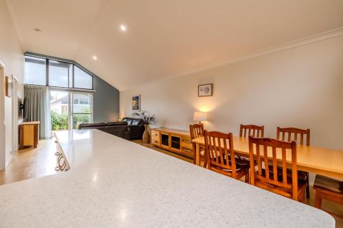 a kitchen and dining room with a table and chairs at Albany Bayside by the BnB Collection in Albany