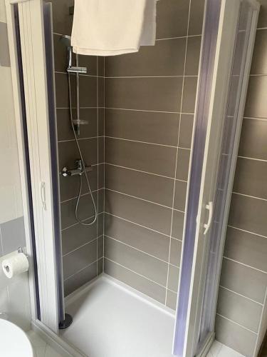 a shower with a glass door in a bathroom at La Casa di Therry bed & breakfast in Viggiano