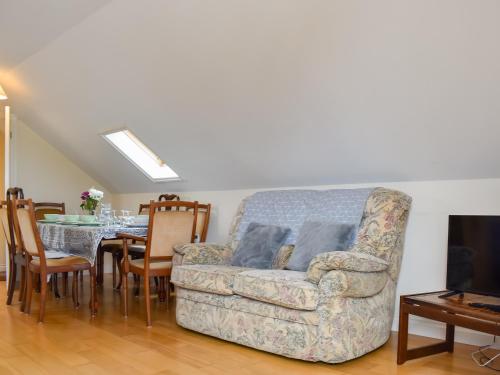a living room with a couch and a table at Lavrean Farm in St Austell
