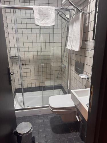 a bathroom with a shower and a toilet and a sink at Big Urban Stay Taksim &With Sea Vıew in Istanbul