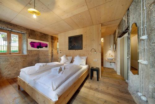 a bedroom with a large bed with white sheets at Cedä-M in Dosoledo