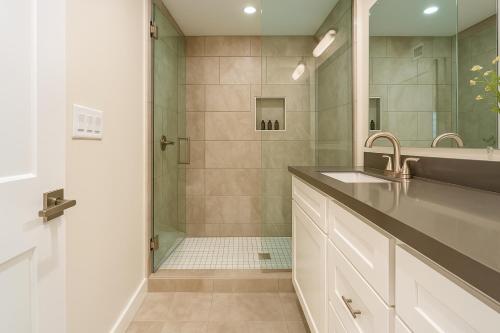 a bathroom with a shower and a sink and a mirror at Brilliance-Fire Pit & Foosball-Middle of Old Town in Scottsdale