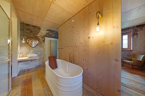 a bathroom with a large tub and a sink at Cedä-M in Dosoledo