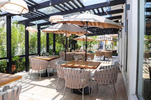 a patio with tables and chairs with umbrellas at Holiday Inn Durango by IHG in Durango