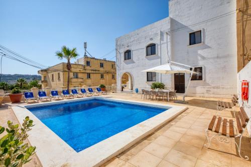 an image of a villa with a swimming pool at Hgieri Holiday Home in Għasri