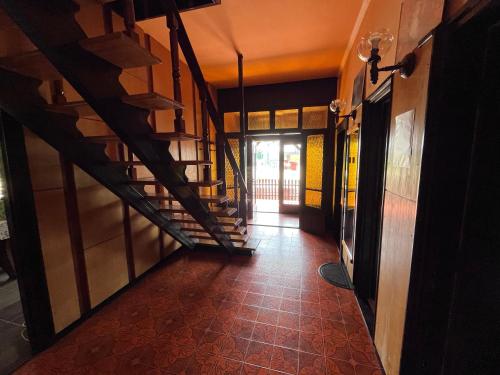 a hallway with a staircase in a building with a floor at Babits Apartman in Tiszakécske