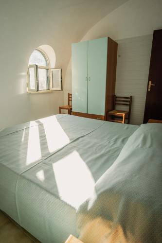a bedroom with a large bed and a cabinet at Camping & Village Rais Gerbi in Pollina