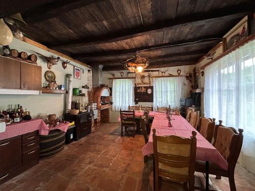 a kitchen and dining room with a table and chairs at Ruralna kuća Pejaković 