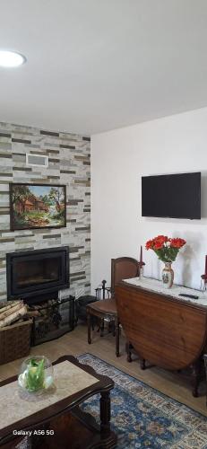 a living room with a wooden tub and a fireplace at Casa dos Avós in Fiães do Rio