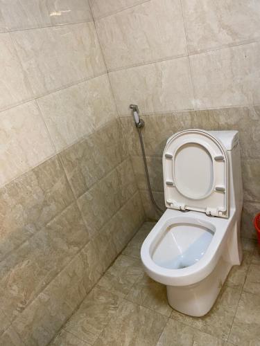 a bathroom with a toilet with the seat up at Wynn hotel in Bahir Dar