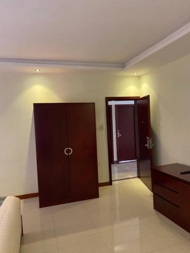 a living room with a brown cabinet and a door at Wynn hotel in Bahir Dar