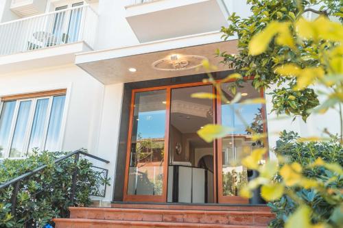 a front door of a white house with stairs at Hotel La Pergola in Sant'Agnello