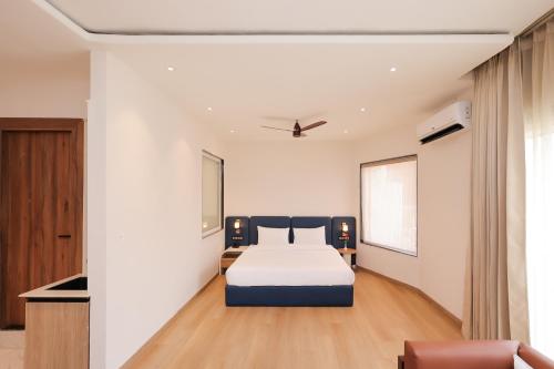 a bedroom with a bed in a room at ECKO Tapovan by the Ganges in Rishīkesh