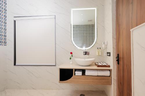 a bathroom with a sink and a mirror at ECKO Tapovan by the Ganges in Rishīkesh