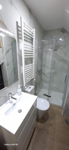 a bathroom with a white sink and a shower at Casa dos Avós in Fiães do Rio