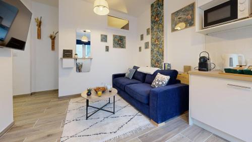 un salon avec un canapé bleu et une table dans l'établissement Le Grand Matabiau, à Toulouse