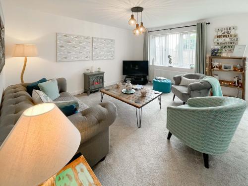 a living room with a couch and chairs and a table at The Light House in Flamborough