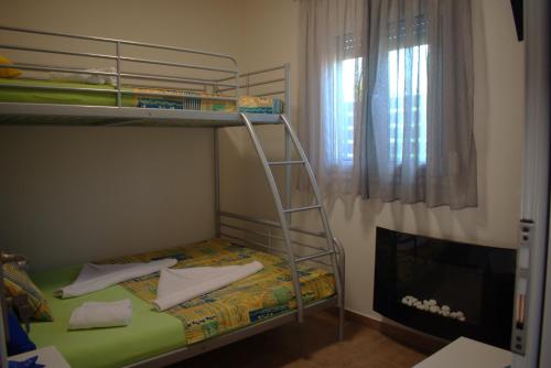 a bunk bed with a ladder in a room at Verde Home in Néa Meságkala