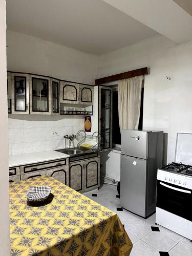 a kitchen with a table and a refrigerator and a stove at Bigapart sity centre, old Tbilisi in Tbilisi City