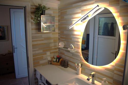 a bathroom with a sink and a mirror at Verde Home in Néa Meságkala