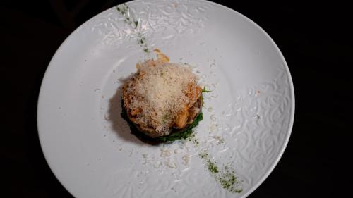 a white plate with a piece of food on it at Villa Balis Crema Verona Hills in Grezzana