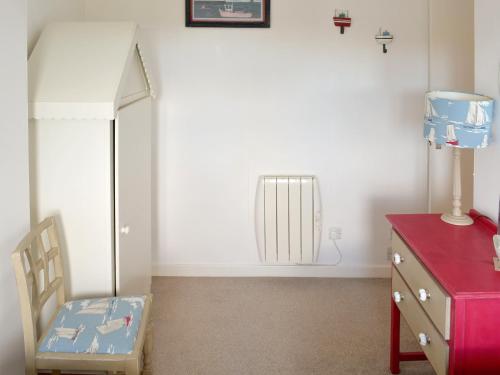 a room with a dresser and a chair and a radiator at Cheviot View in Beal