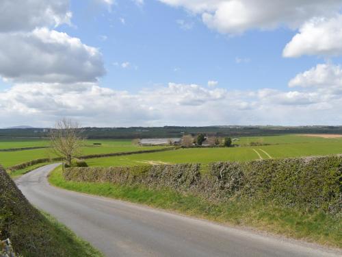 a road in the middle of a field at Cheviot View in Beal