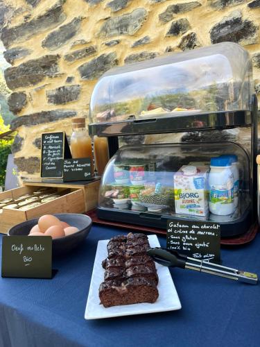 a table with a plate of brownies and eggs at La Magnanerie de Camias in Saint-André-de-Majencoules
