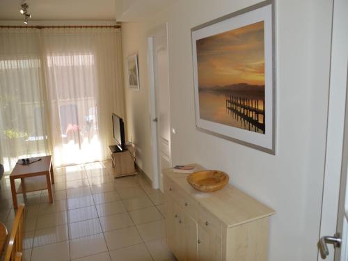 a living room with a painting on the wall at Estartit Park PB-1 in Torroella de Montgrí
