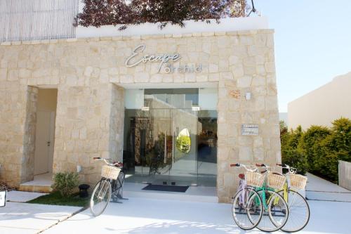 two bikes are parked outside of a store at Escape by Orchid in Batroûn