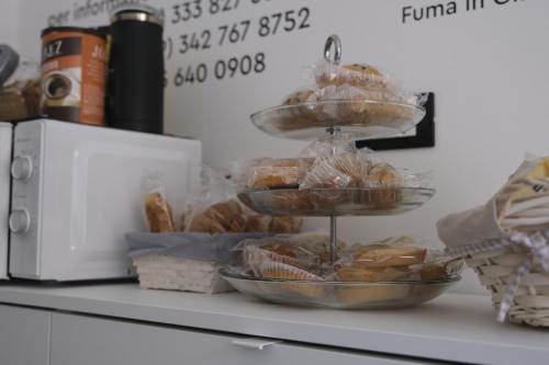 a tray of pastries sitting on a counter next to a microwave at Nonna Francesca 2 in Patti