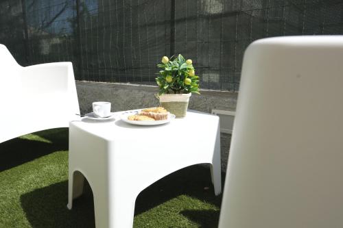 a table with a plate of food and a plant on it at Nonna Francesca 2 in Patti