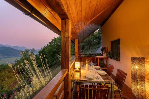 a dining room with a table and chairs on a balcony at Herbal Apartment Marjetka in Šentjur