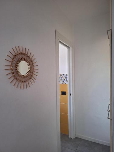 a mirror on a wall next to a hallway at Mini appartamento vicino al lago in Dormelletto